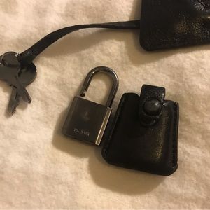 Authentic Prada lock and key. Gunmetal and supple black Italian leather